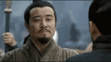 a man with a beard is looking at another man with the word jump on the screen