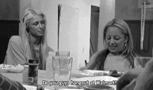 a black and white photo of two women sitting at a table with the words do you guys hangout at walmart