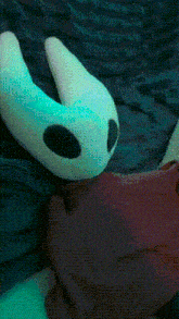 a blue and white stuffed animal with black spots on it