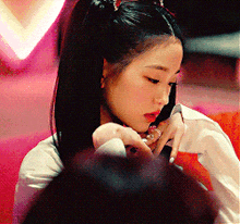a close up of a woman with a ponytail