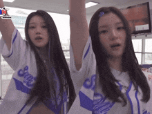 a girl in a purple and white jersey with the word says on it