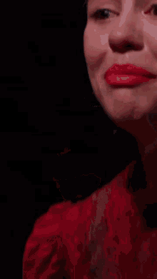 a close up of a woman 's face with her mouth open