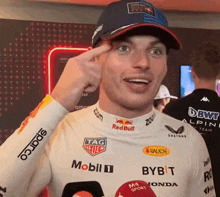 a man wearing a red bull shirt and a tag heuer shirt