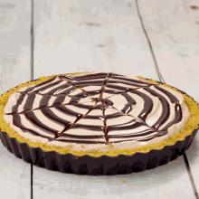 a pie with a spider web design on it is on a table