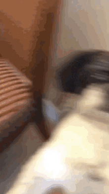 a blurred image of a person sitting on a bed