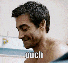 a shirtless man is smiling with the word ouch above his head