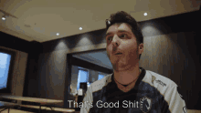 a man wearing a shirt that says ' that 's good shit ' on it