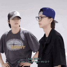 a couple of people standing next to each other and one of them is wearing a shirt that says she
