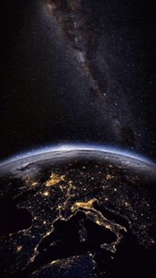 a view of the earth at night with the milky way visible