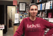 a woman wearing a red sweatshirt that says love raiders