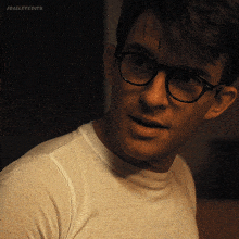 a close up of a man wearing glasses and a white shirt with the words jbajleyedits below him