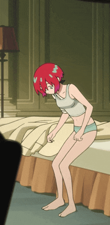 a girl with red hair is kneeling on a bed looking down