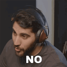 a man wearing headphones says " no " in white letters