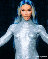 a woman with blue hair is wearing a bodysuit with sparkles on it
