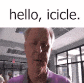 a man in a purple shirt is standing in a room with the words hello , icicle . written above him .
