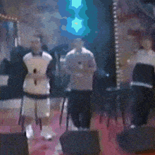 a blurry picture of a group of people standing around a stage