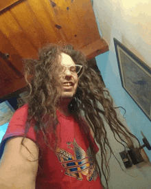 a man with dreadlocks is wearing an adidas t-shirt