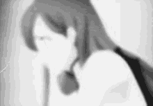 a black and white photo of a woman with long hair and a backpack .