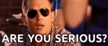a man wearing sunglasses and a plaid shirt is saying `` are you serious '' .