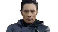 a man is pointing at the camera with a gun