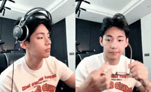 a young man wearing headphones is holding a pair of glasses in his hand .