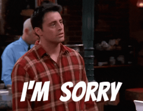 a man in a plaid shirt says i 'm sorry in white letters
