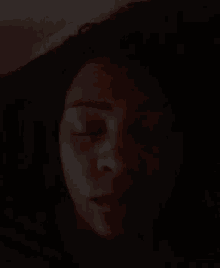 a close up of a woman 's face in the dark .