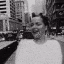 a black and white photo of a woman with a towel around her mouth .