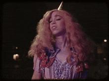 a woman with long blonde hair is wearing a cowboy outfit