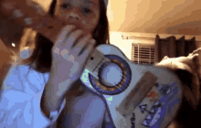 a girl is playing a guitar with the letter a on the back