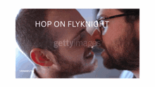 a picture of two men kissing with the words hop on flyknight above them