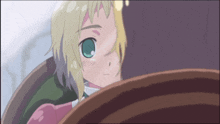 a girl with blonde hair and green eyes is looking at something