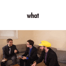 a group of men sitting on a couch with the word what on the bottom