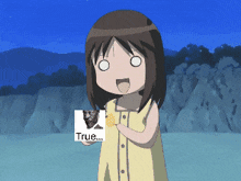 a girl in a yellow shirt is holding a picture of a cat and the words true
