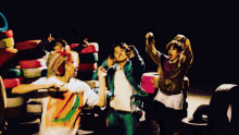 a group of young men are dancing in front of stacks of tires .