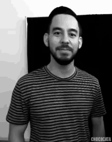 a black and white photo of a man in a striped shirt