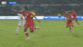 a soccer game is being played on a field with a sign that says tecno on it