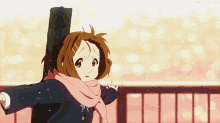 a girl with a scarf around her neck is holding a guitar case over her shoulder