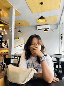 a woman wearing a white shirt that says nevada on it