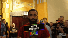 a man with a sign that says " keita murray " on it