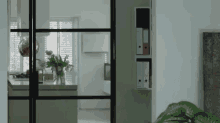 a room with a sliding glass door leading to a kitchen and a living room .