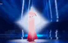 a woman in a red dress stands on a stage in front of a blue background that says 1 hd on the bottom