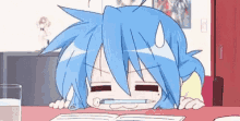 a cartoon girl with blue hair is sitting at a table with a book and a pen in her mouth .