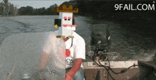 a man in a cowboy hat is sitting in a boat with 9fail.com written on the bottom right