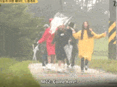 a group of people holding umbrellas with the words mc2 come here