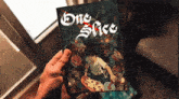 a person holding a book called one spice