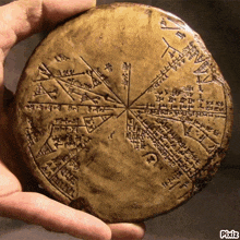 a person is holding a piece of clay with writing on it that says ' pixiz ' at the bottom