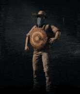 a man in a straw hat holds a target in his hand