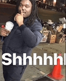 a man with dreadlocks holds his finger to his lips and says " shhhh "