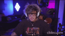 a man wearing headphones and a shirt that says ' supreme '